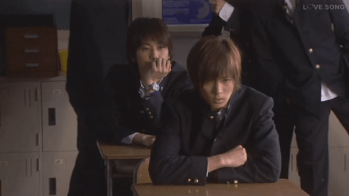 Ken sits in front of Mikio